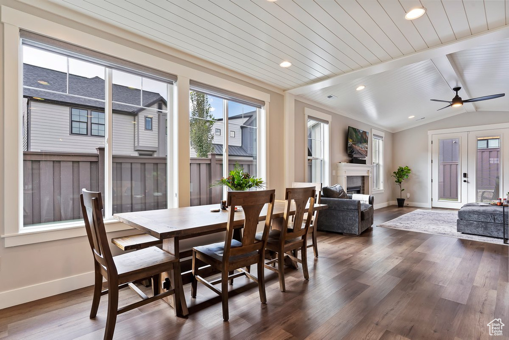 Dining space featuring baseboards, dark wood finished floors, a fireplace, a ceiling fan, and recessed lighting