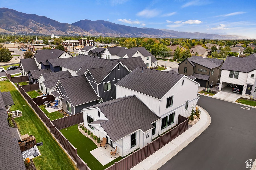 Aerial perspective of suburban area featuring a mountainous background