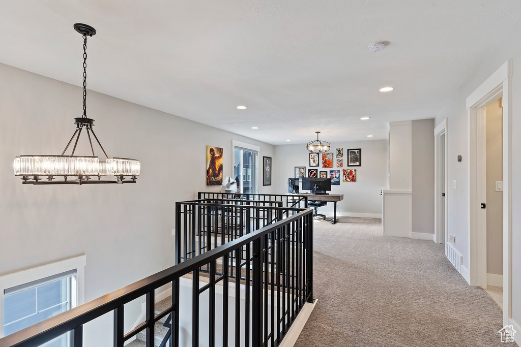 Hallway with a chandelier, an upstairs landing, carpet floors, recessed lighting, and baseboards