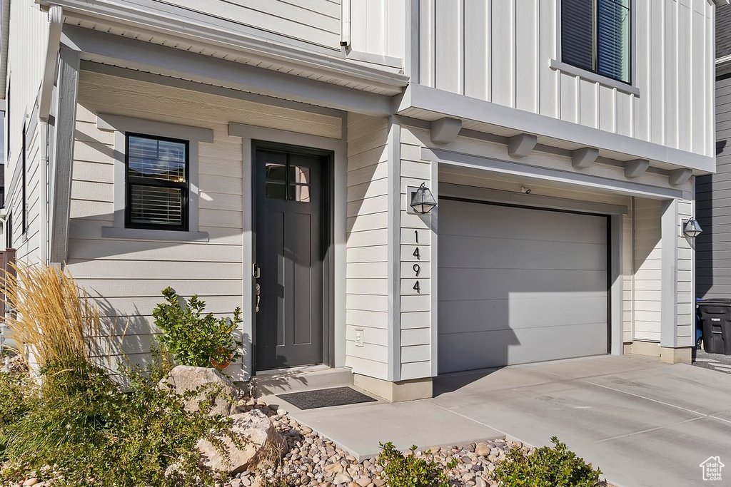 Property entrance featuring a garage and board and batten siding