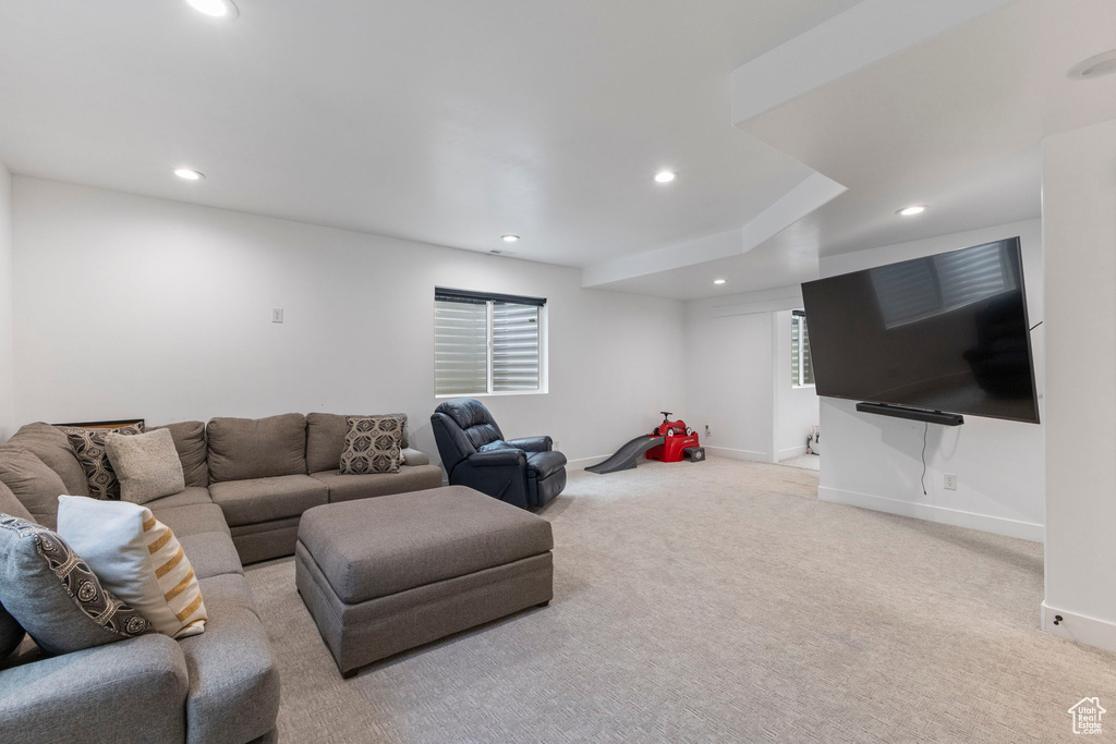 Living room with recessed lighting, light colored carpet, and baseboards