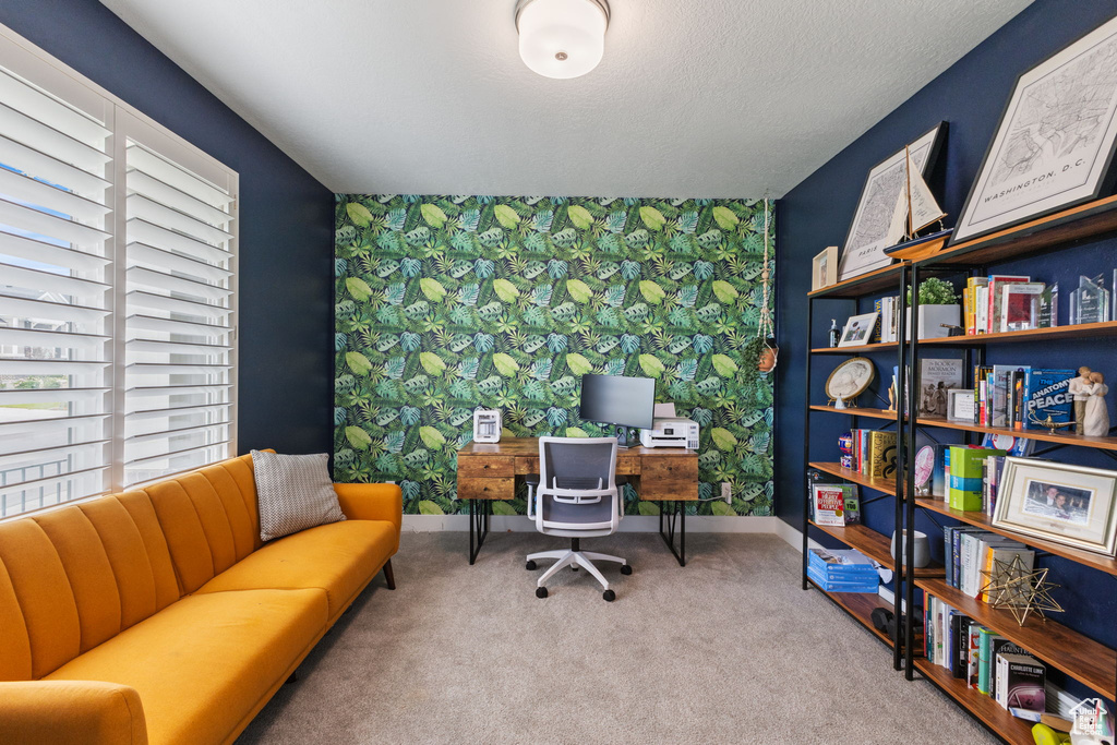 Office space featuring an accent wall, wallpapered walls, baseboards, and carpet floors