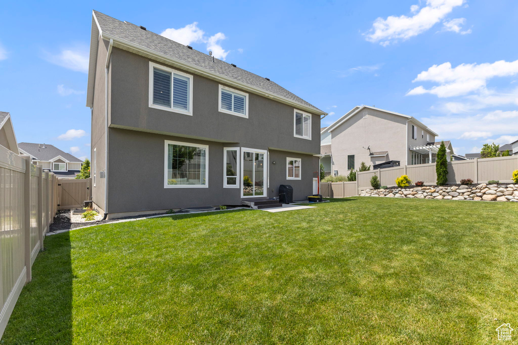 Rear view of property featuring stucco siding and a residential view
