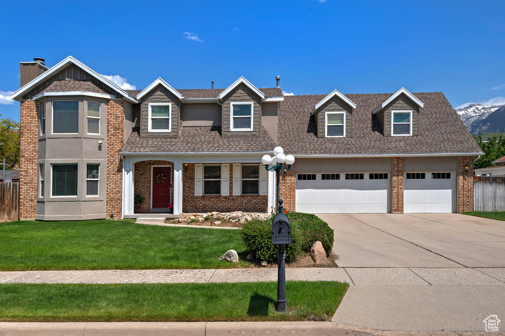 View of front of house featuring concrete driveway, a garage, brick siding, and a shingled roof