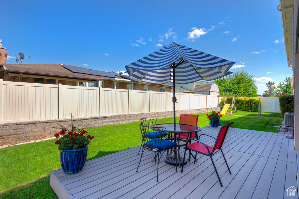 Deck featuring outdoor dining area and a playground