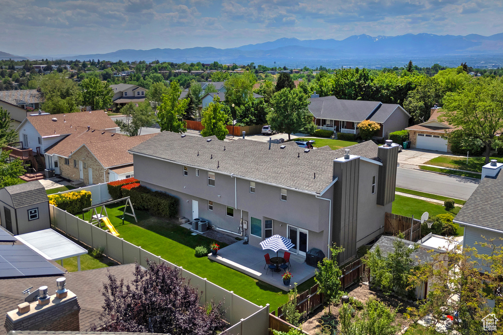 Aerial perspective of suburban area with a mountainous background