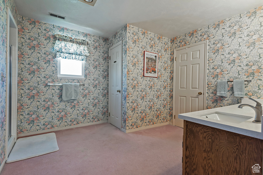 Bathroom featuring vanity and baseboards