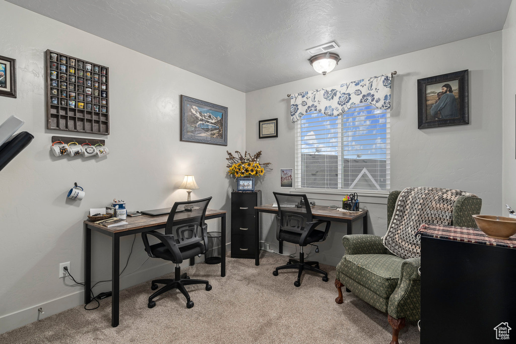 Office space with carpet and baseboards