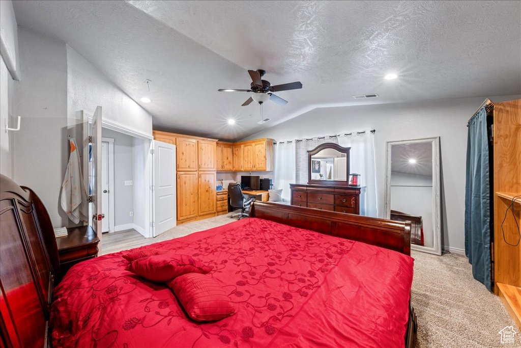 Bedroom with vaulted ceiling, baseboards, a textured ceiling, recessed lighting, and light carpet