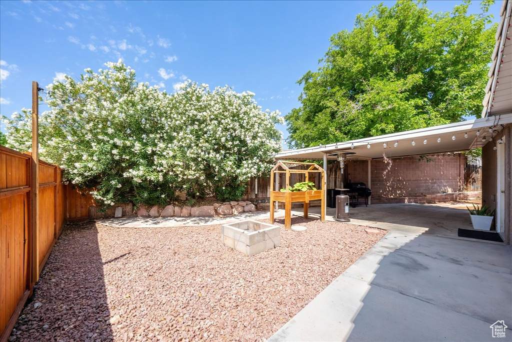 Fenced backyard featuring a patio and a fire pit