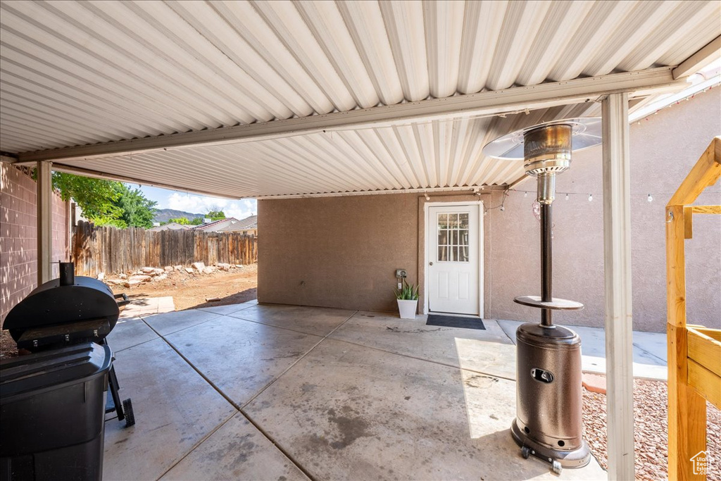 View of patio with a grill