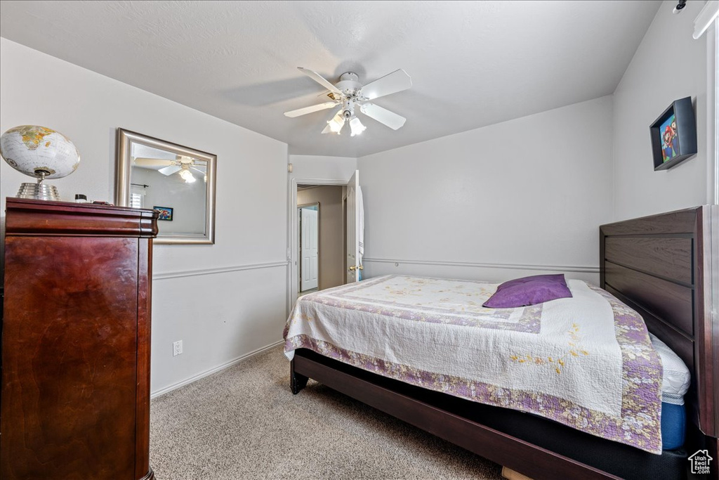 Bedroom with carpet floors, a ceiling fan, and baseboards
