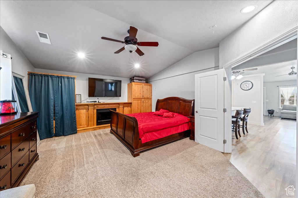 Bedroom with lofted ceiling, light carpet, recessed lighting, and a ceiling fan