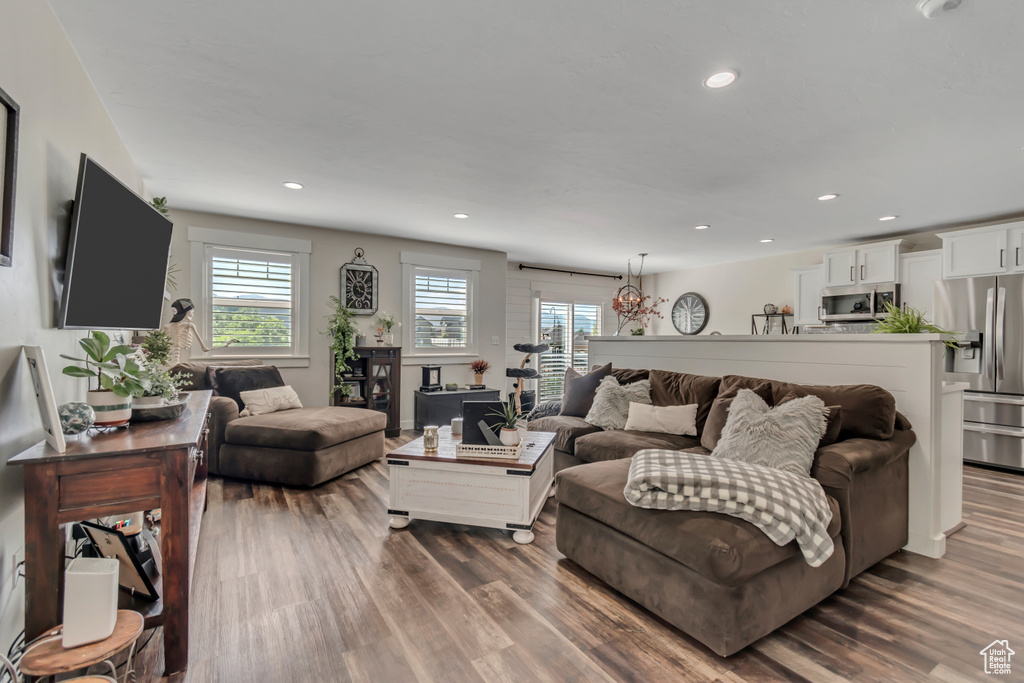 Living room with dark wood-type flooring and recessed lighting