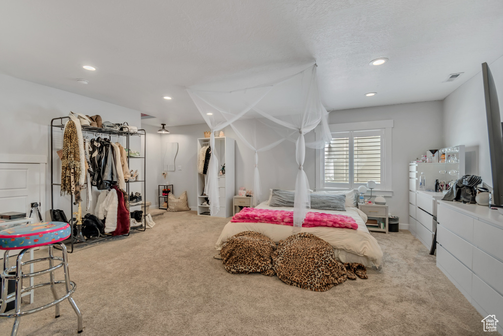 Carpeted bedroom with recessed lighting