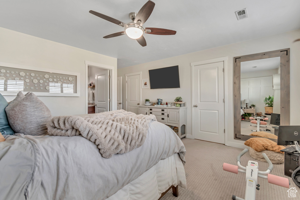 Bedroom featuring light carpet and a ceiling fan