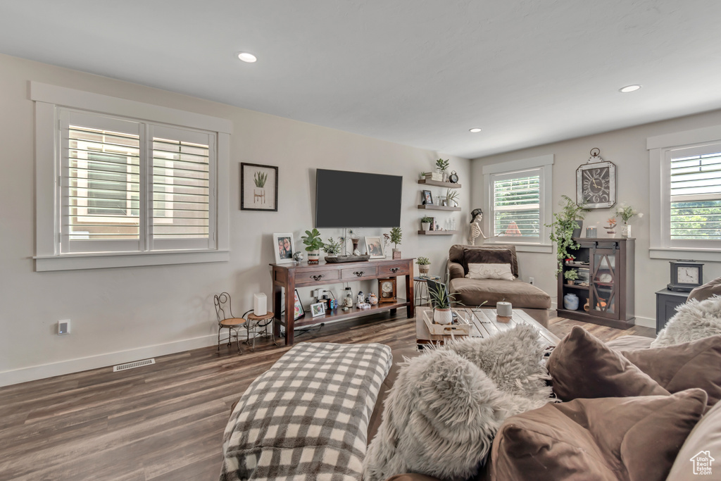 Living area featuring healthy amount of natural light, wood finished floors, baseboards, and recessed lighting