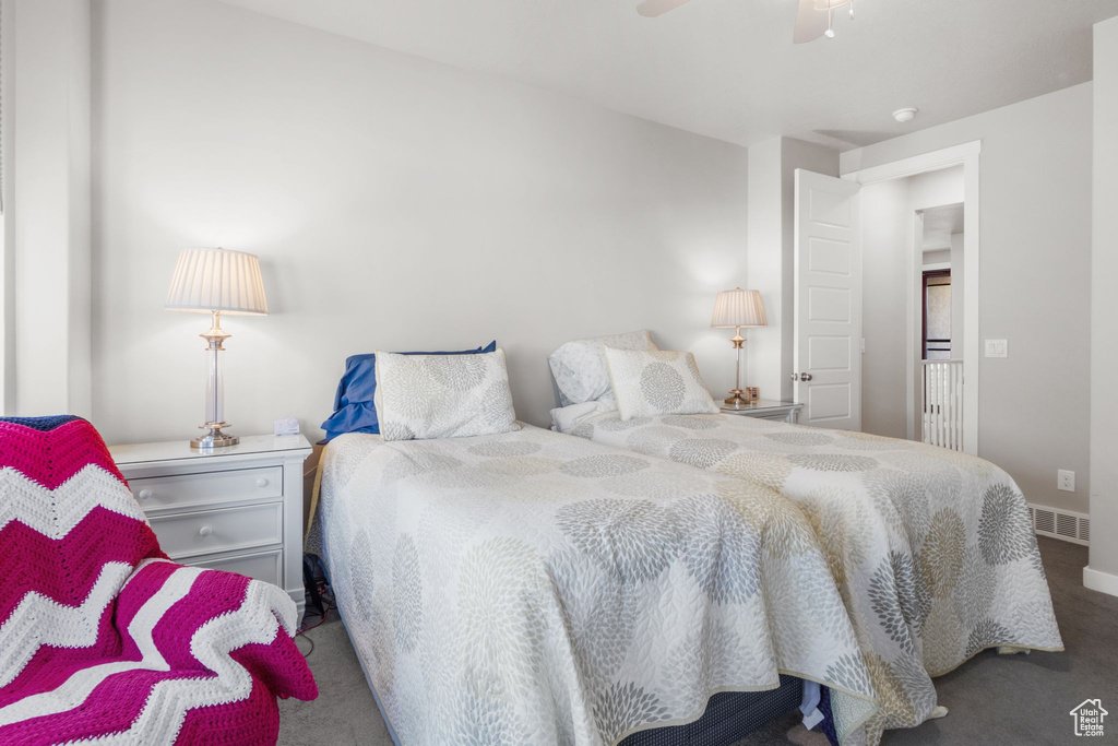Carpeted bedroom featuring ceiling fan