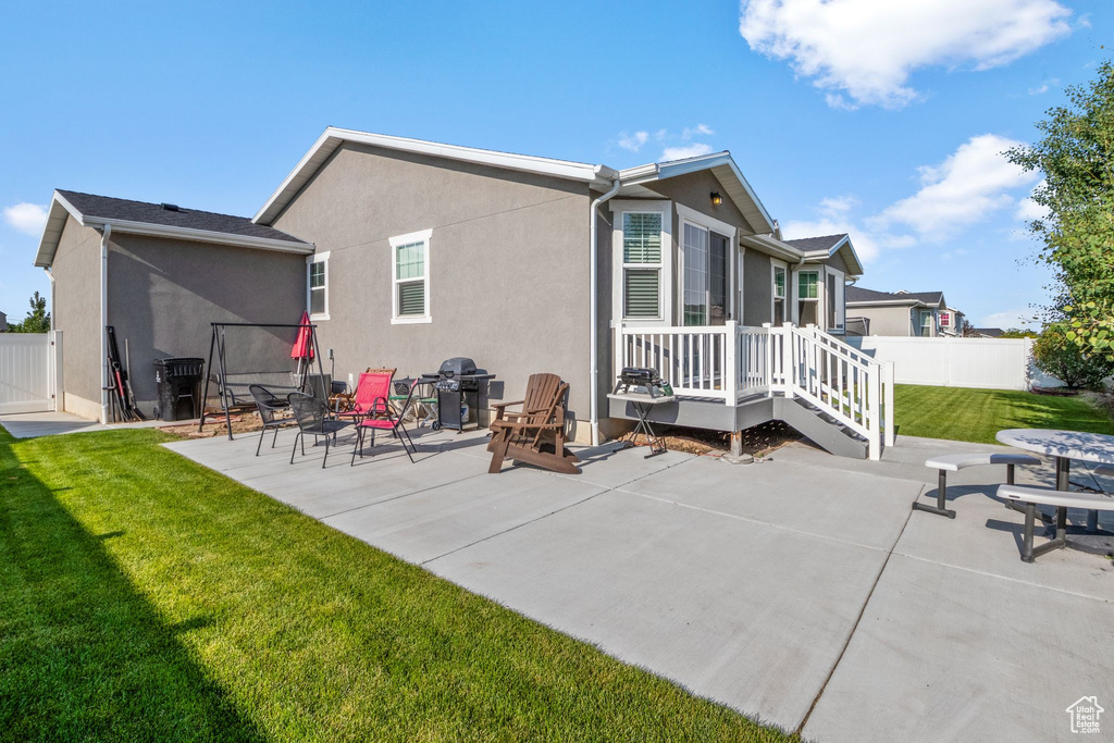 Rear view of property with stucco siding and a patio