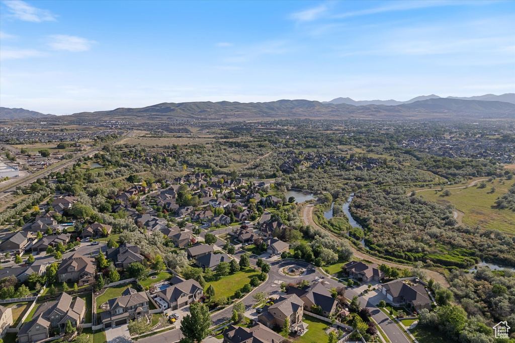 Aerial overview of property's location with mountains and nearby suburban area