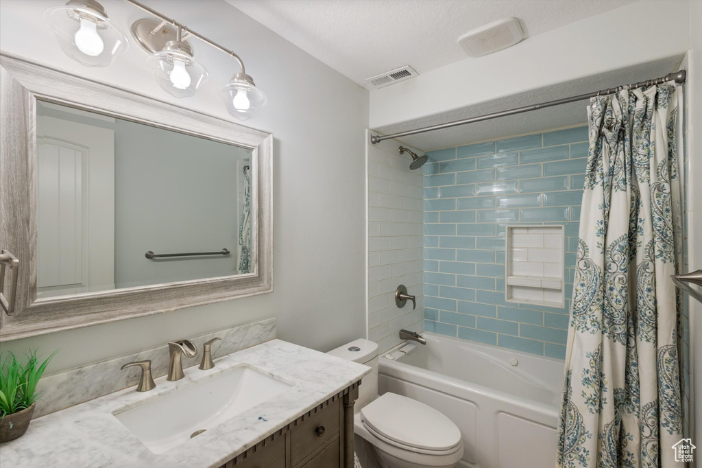 Full bath with vanity, toilet, and shower / bathtub combination with curtain
