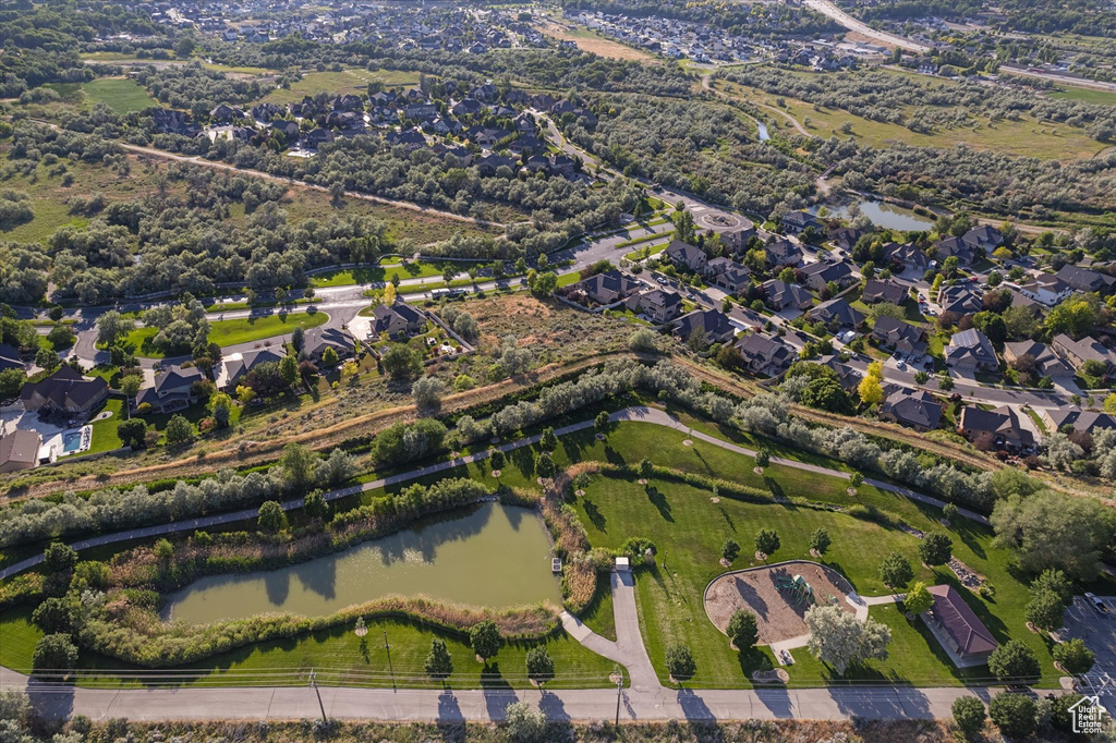 Aerial view of property and surrounding area with a nearby body of water and nearby suburban area