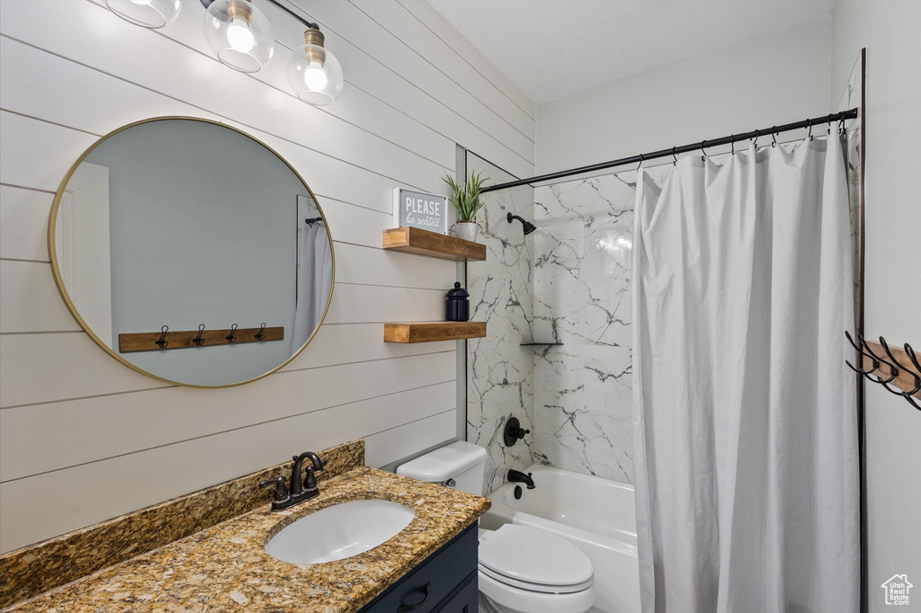 Full bath with vanity, shower / bathtub combination with curtain, and toilet
