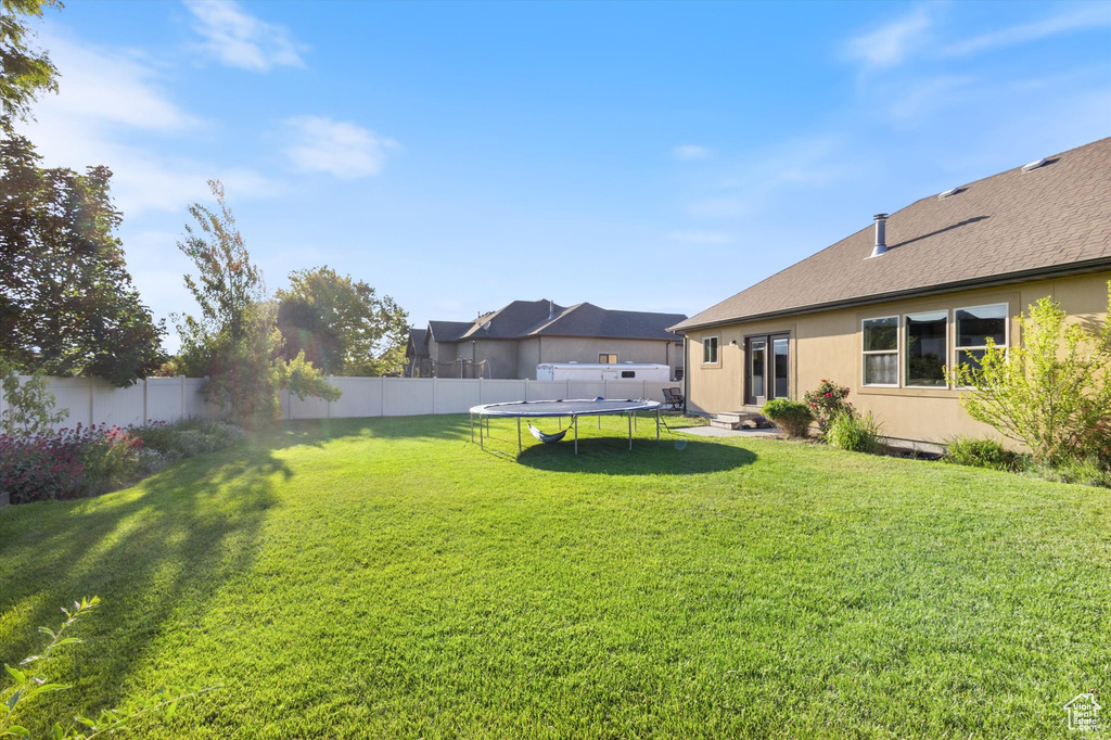 View of yard with a trampoline