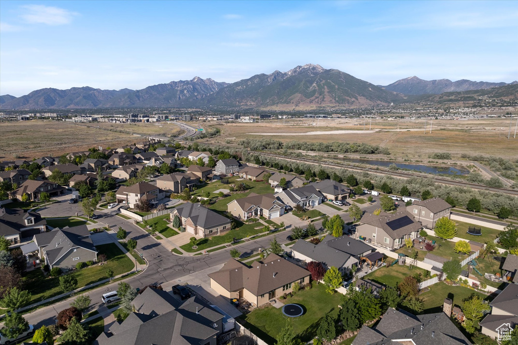 Aerial view of property and surrounding area with mountains and nearby suburban area