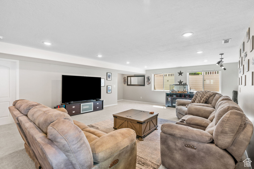 Living room featuring light colored carpet, recessed lighting, and baseboards