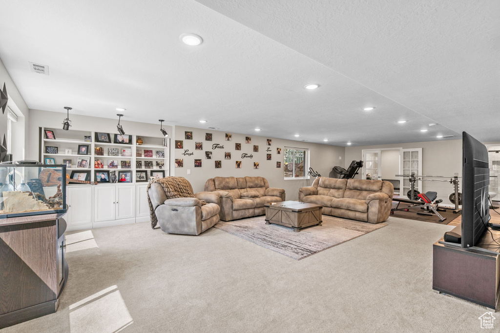 Carpeted living area featuring recessed lighting