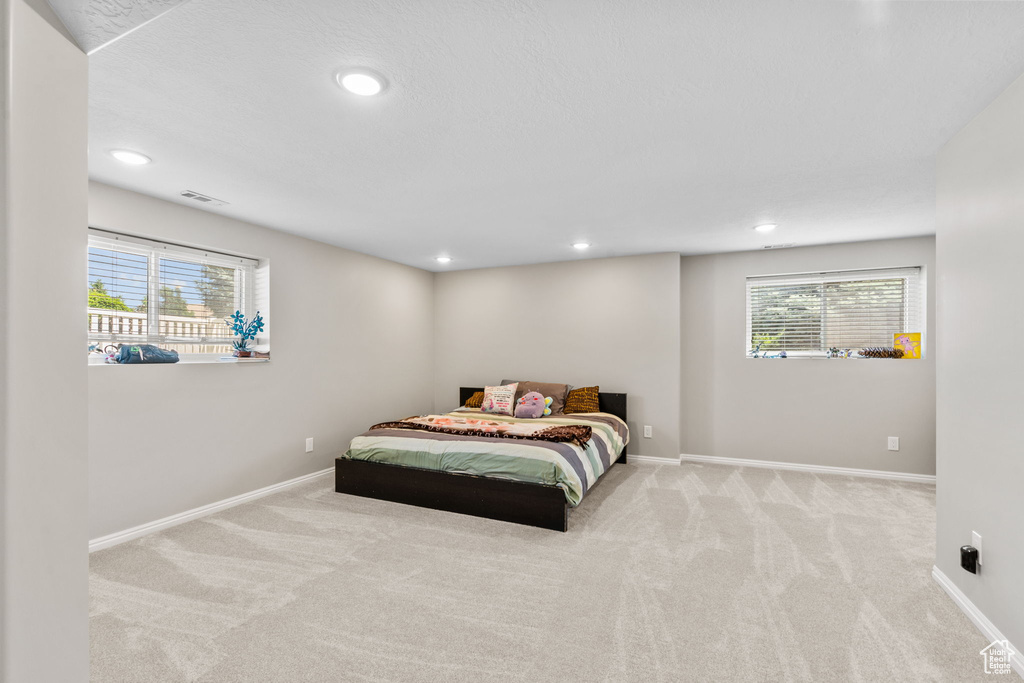 Carpeted bedroom featuring baseboards and recessed lighting