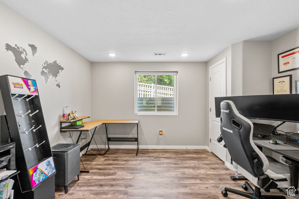 Office with wood finished floors, baseboards, and recessed lighting
