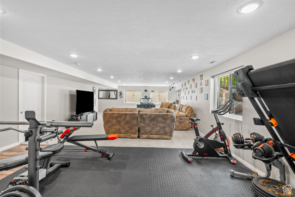 Workout area featuring recessed lighting, baseboards, and a textured ceiling