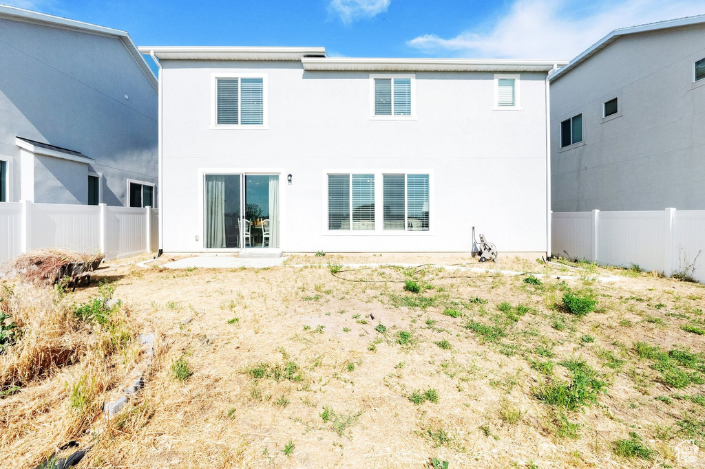 Back of property featuring stucco siding