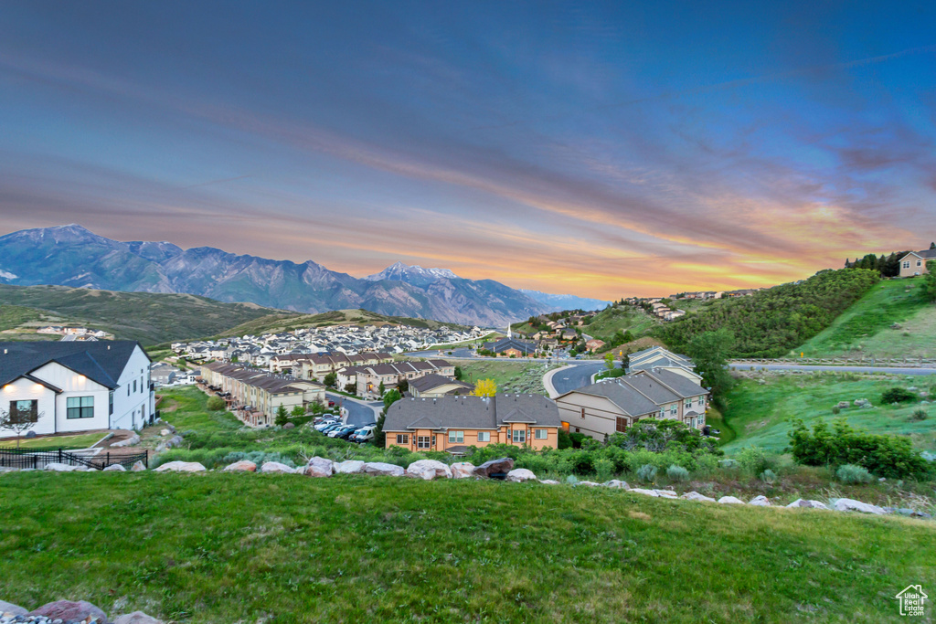 View of mountain backdrop featuring nearby suburban area