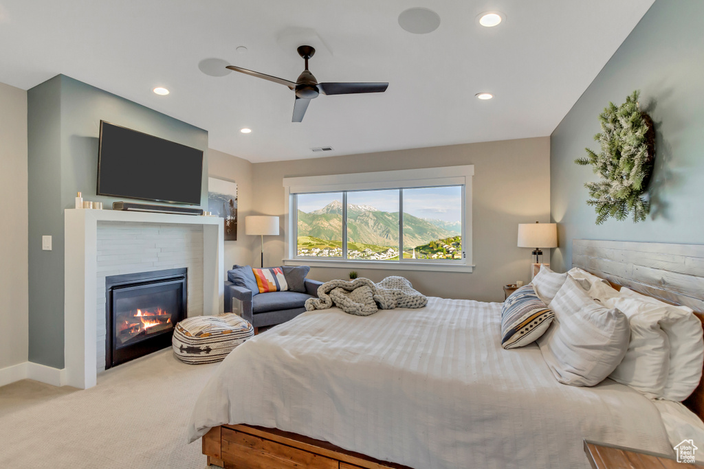 Bedroom featuring carpet floors, a glass covered fireplace, recessed lighting, baseboards, and a ceiling fan