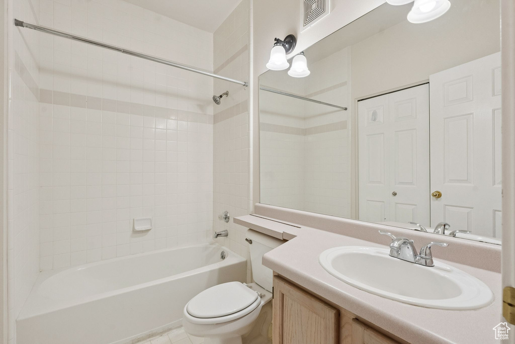 Full bathroom with toilet, tub / shower combination, and vanity
