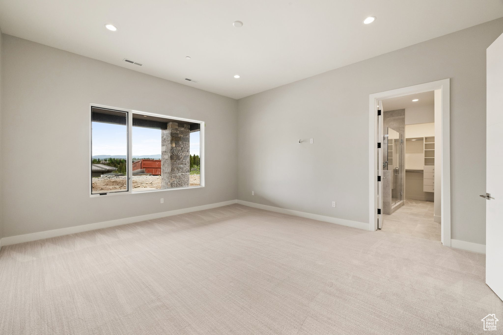 Unfurnished room featuring light carpet, recessed lighting, and baseboards