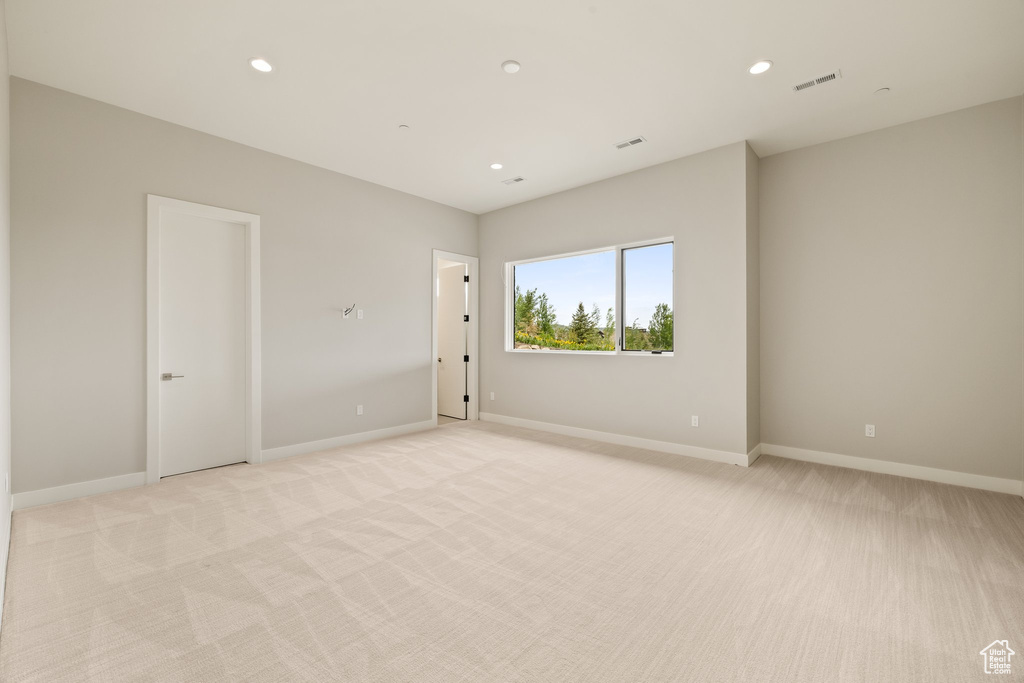 Unfurnished room with light colored carpet, recessed lighting, and baseboards