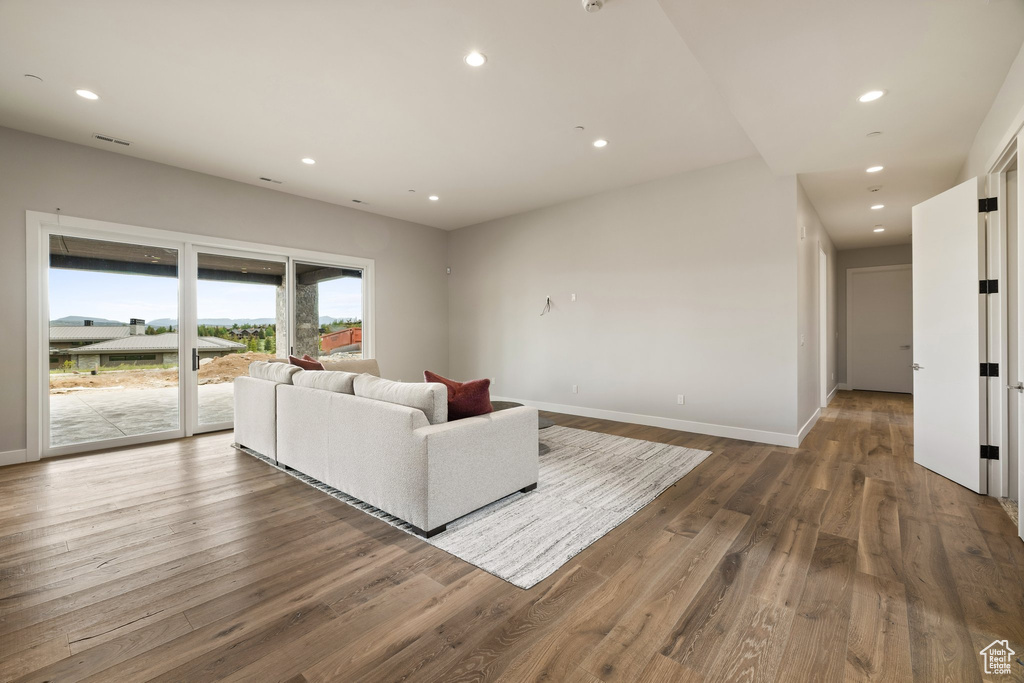 Living room featuring wood finished floors, recessed lighting, and baseboards