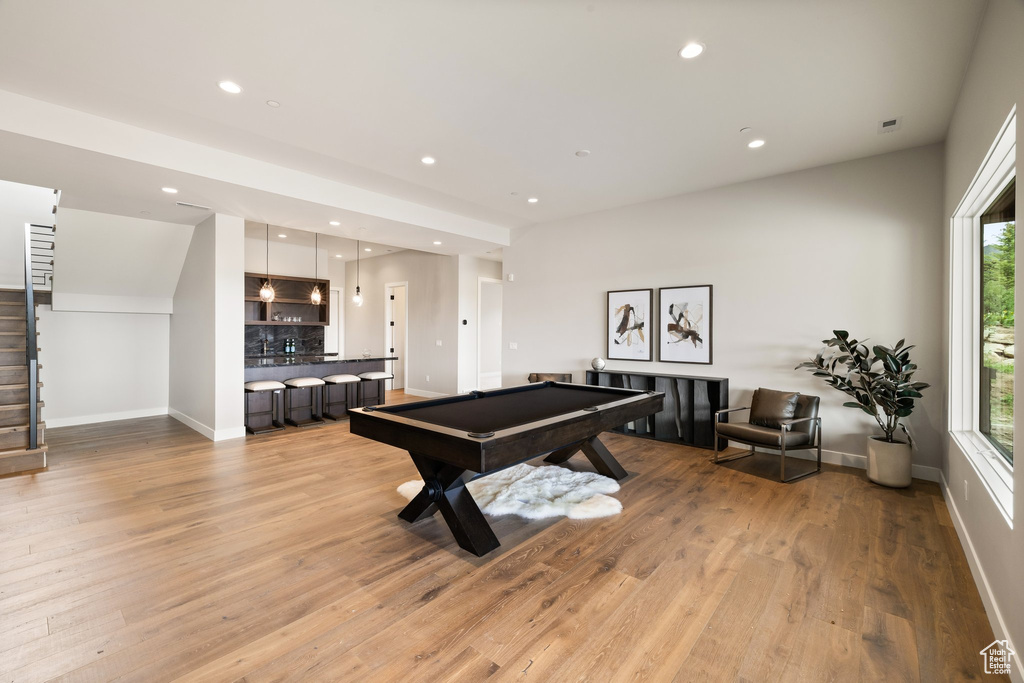 Rec room featuring bar with sink, billiards, light wood-style floors, baseboards, and recessed lighting
