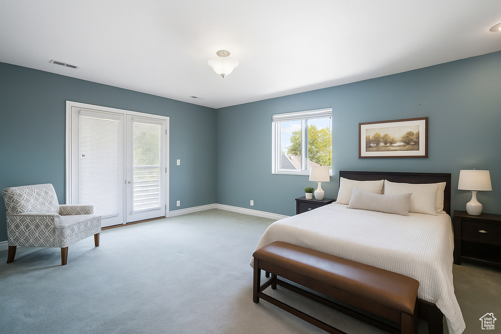 Carpeted bedroom with access to outside and baseboards