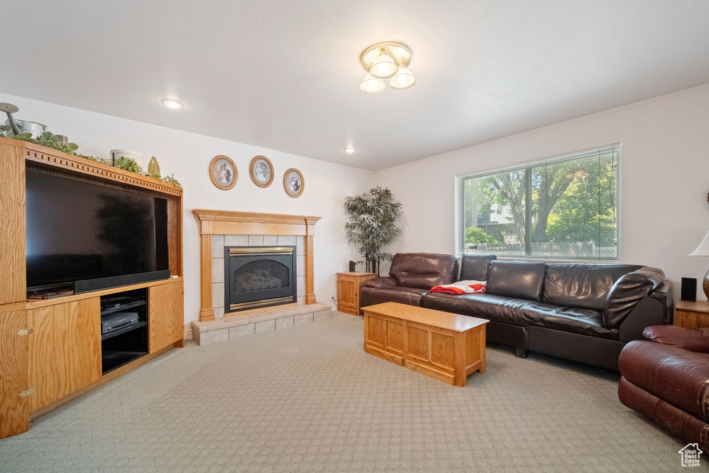 Living area featuring carpet floors and a tiled fireplace