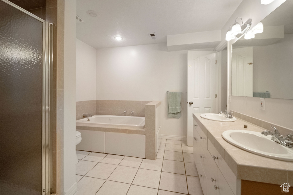 Bathroom with tile patterned floors, a garden tub, double vanity, a stall shower, and recessed lighting