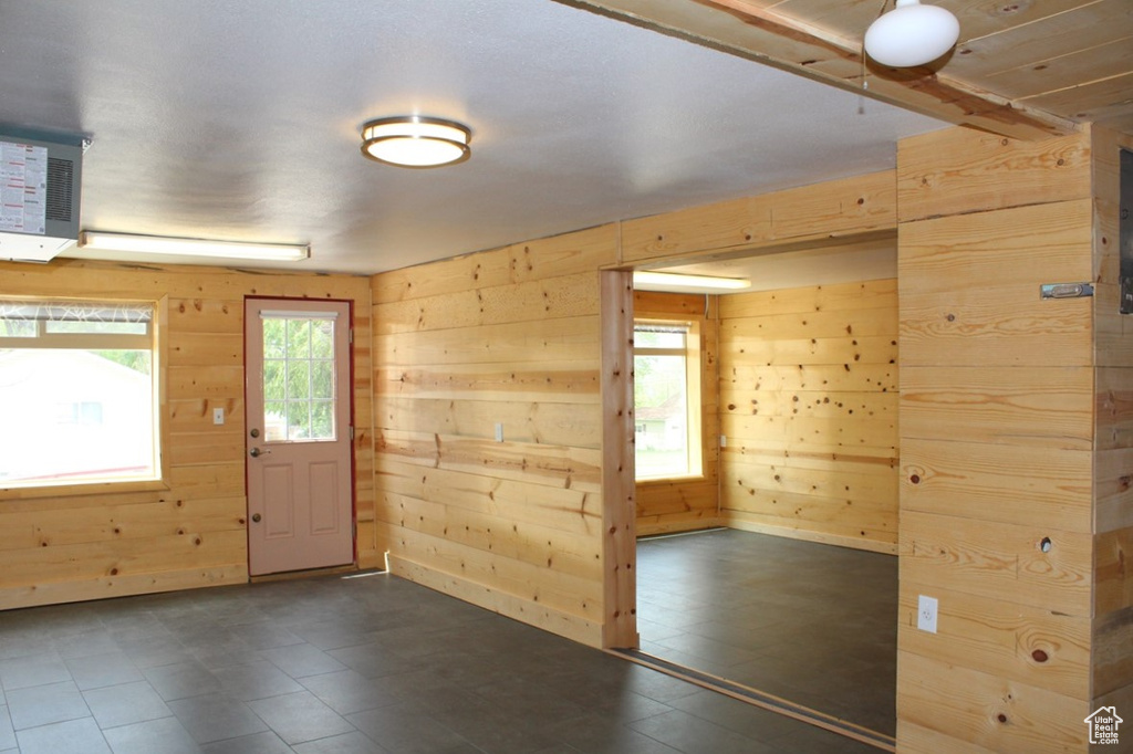 Entrance foyer featuring wood walls