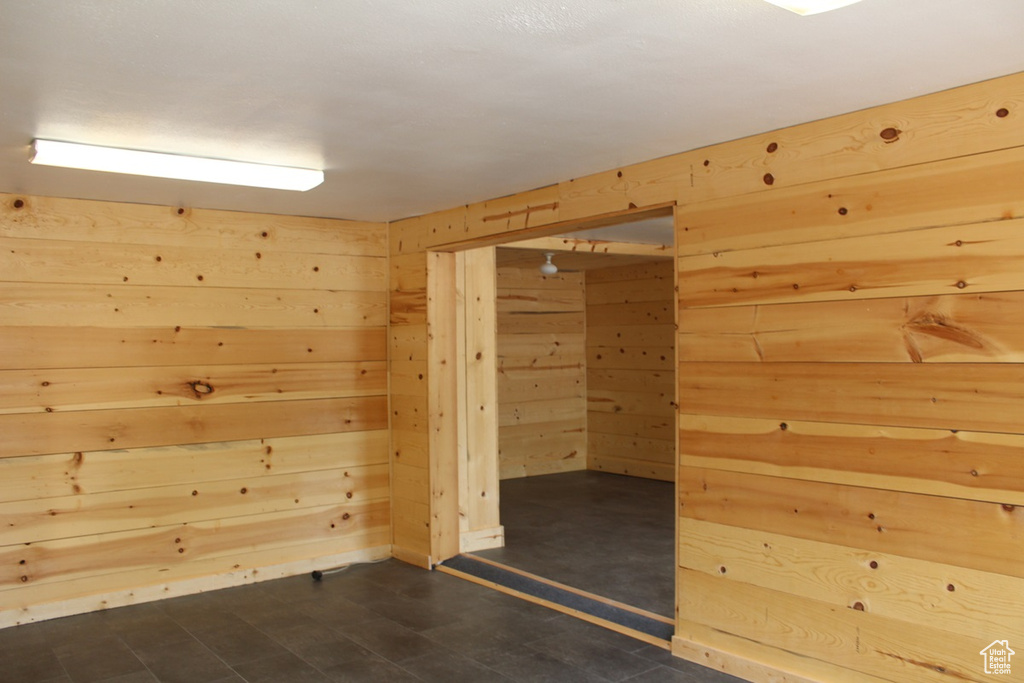 Bonus room featuring wood walls
