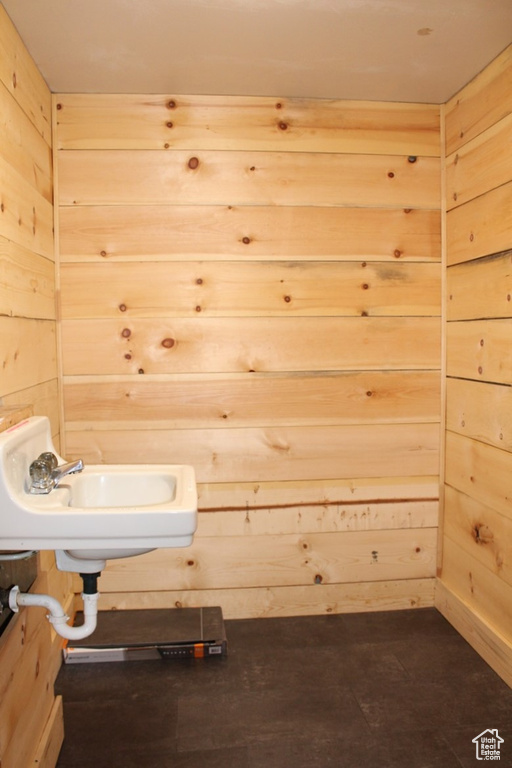 Bathroom featuring wooden walls
