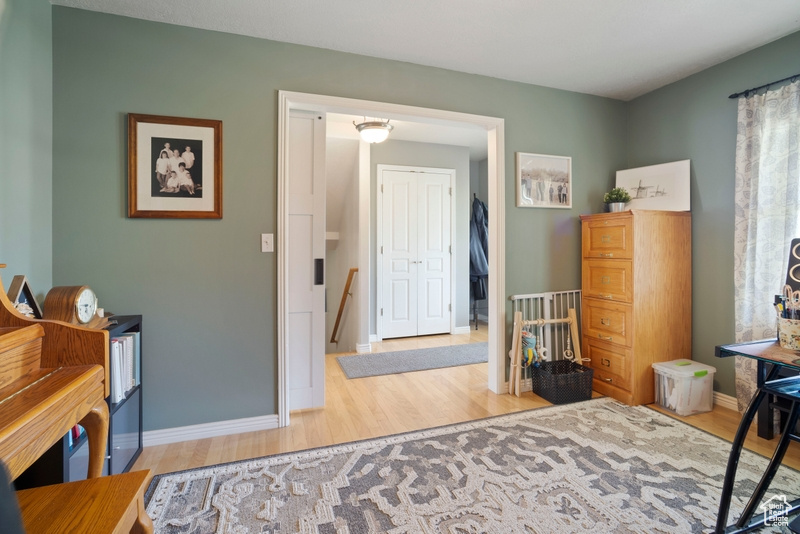 Bedroom with wood finished floors and baseboards