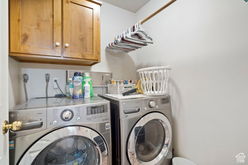 Laundry room featuring washing machine and dryer and cabinet space